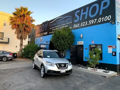 X Designs Collision Center Inc